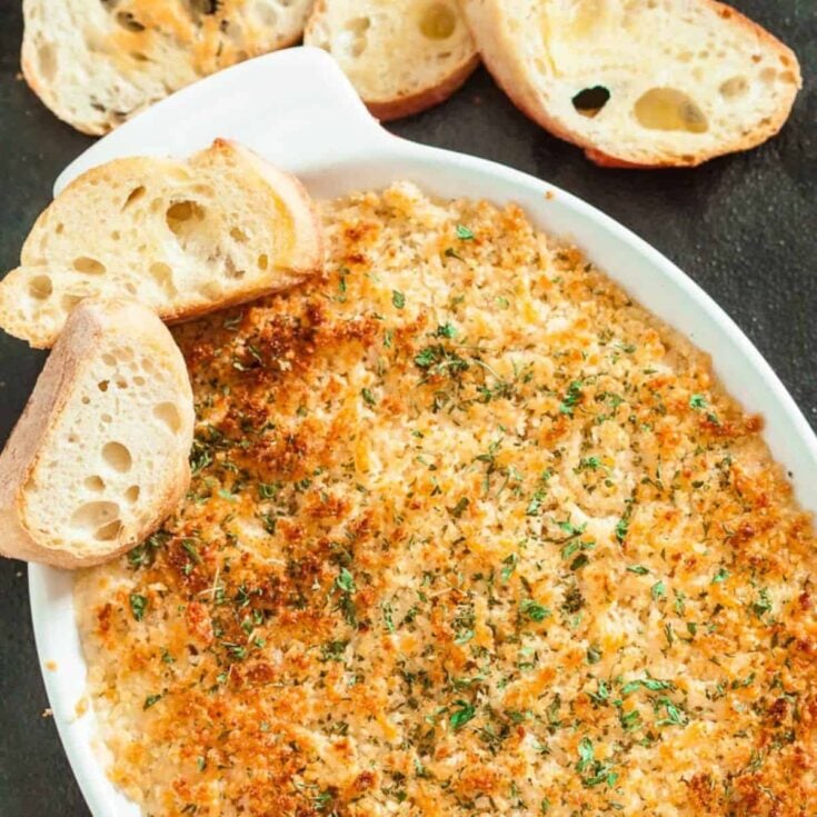 Jalapeno popper party dip with sliced bread on the side