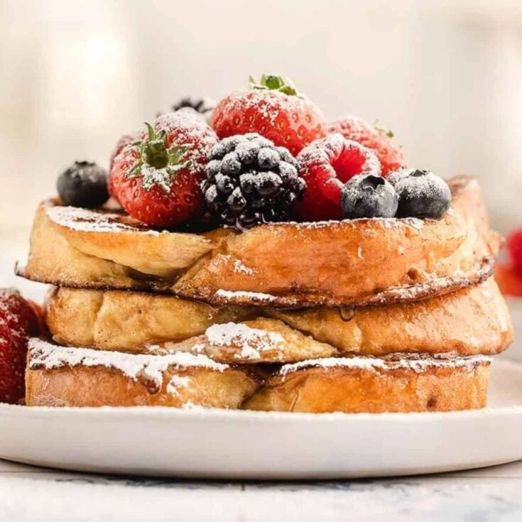 Classic French toast topped with raspberries, strawberries, and blueberries