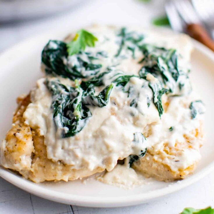 A plate of creamy chicken Florentine, made after reading these Fall dinner party recipes