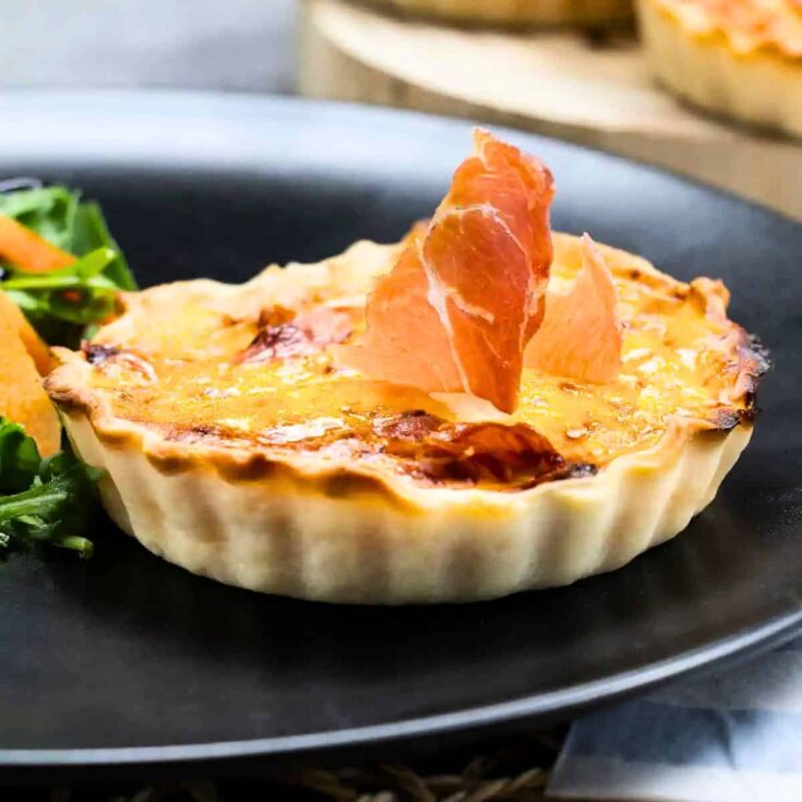 A plate of mini pumpkin quiches appetizer, made after reading these Fall dinner party recipes