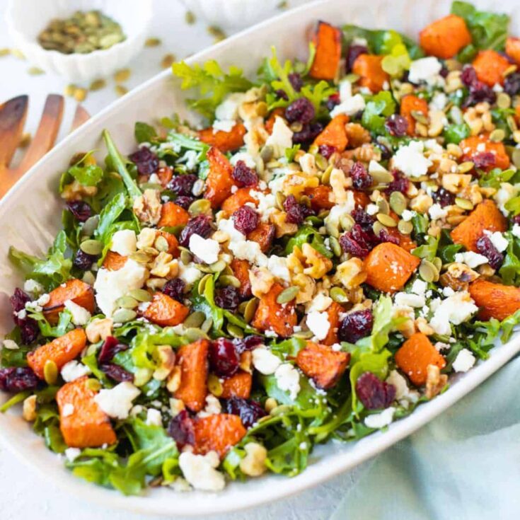 A big serving of pumpkin salad side, with the text overlay Fall dinner party