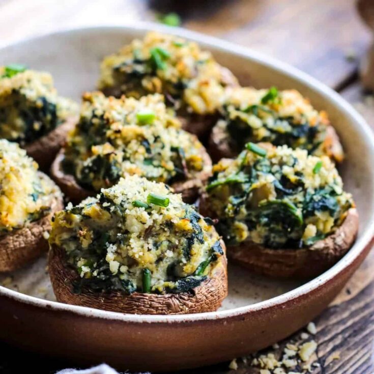 Vegan stuffed mushrooms appetizer on a plate, made after reading these Fall dinner party recipes